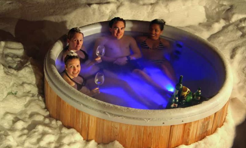 an outdoor hot tub with snow