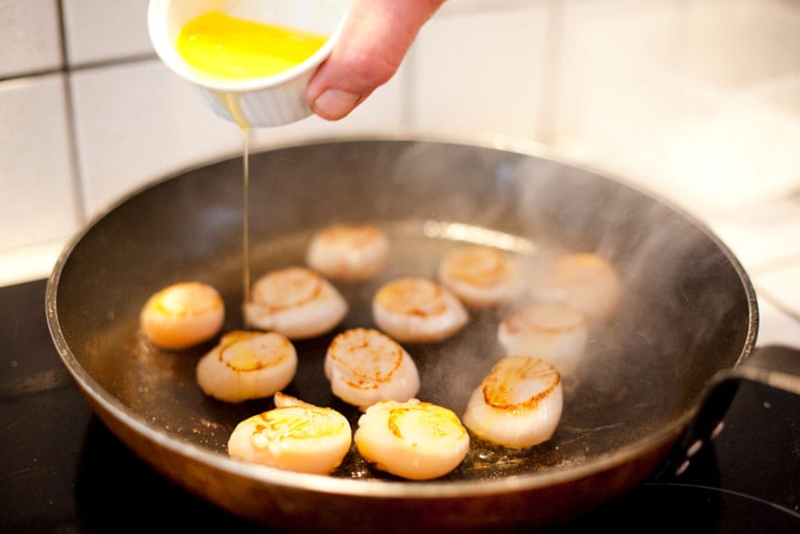 image of fresh scallops being drizzled in butter