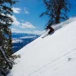 man skiing down a slope