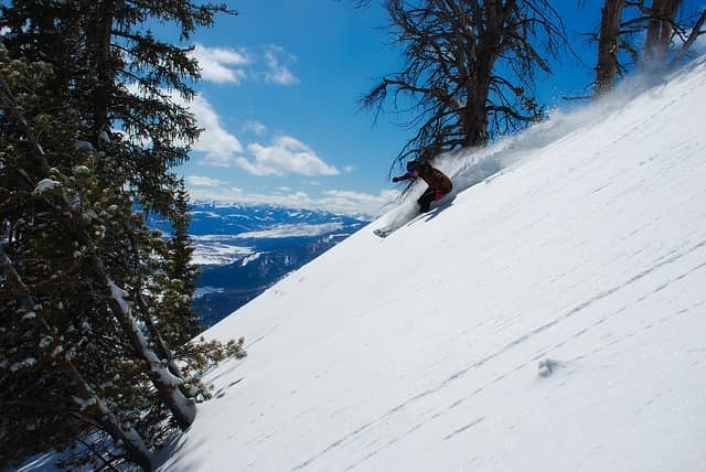 man skiing down a slope